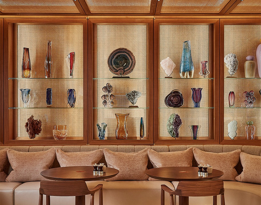 Surrenne Cafe, colourful ornaments and vases line the brightly lit wooden shelves